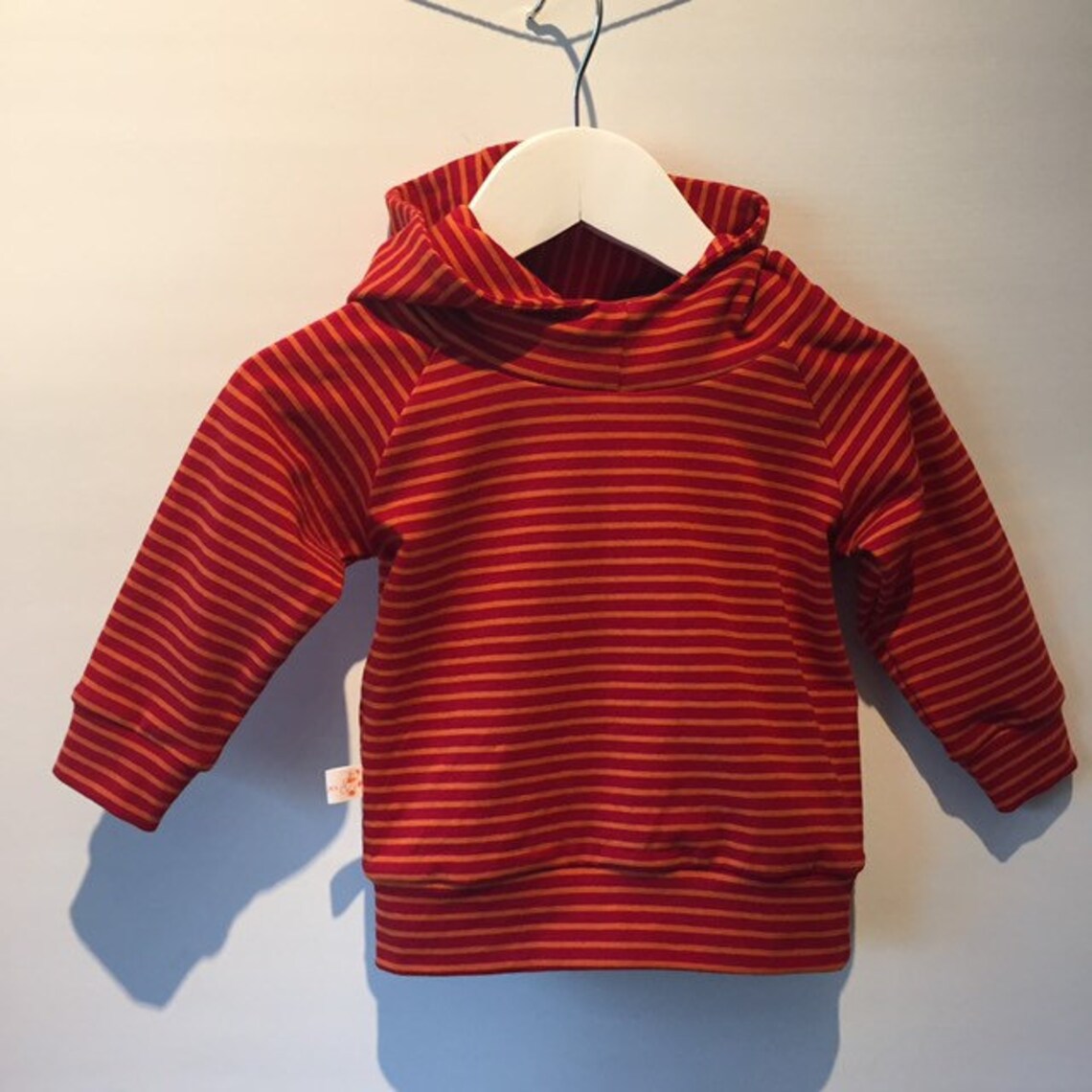 red and orange striped sweater