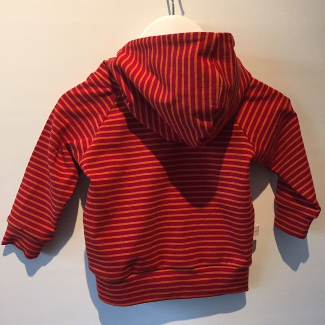red and orange striped sweater