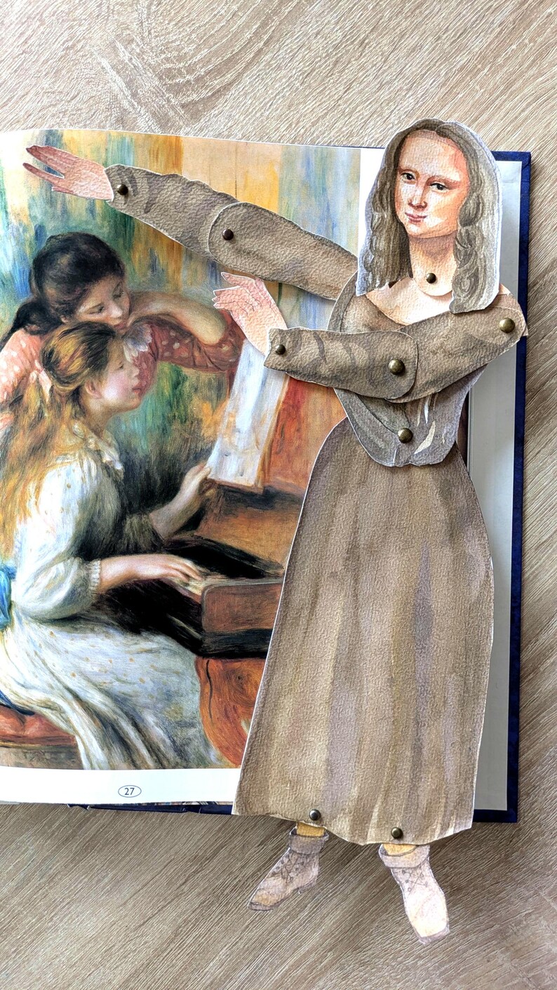 May include: A pop-up book featuring a paper cutout of the Mona Lisa with articulated arms and legs. The background shows a painting of women around a piano. The cutout is wearing a brown dress and jacket.