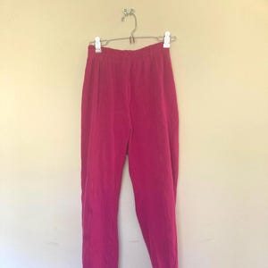 May include: Pink dance pants with stirrups. The pants are made of a soft, stretchy fabric and have a comfortable fit.