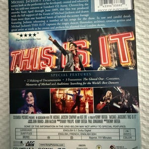 May include: The back cover of the Michael Jackson THIS IS IT DVD features a large image of the performer on stage, text summaries, a barcode, and a list of special features including documentaries and featurettes about costumes and dancers.