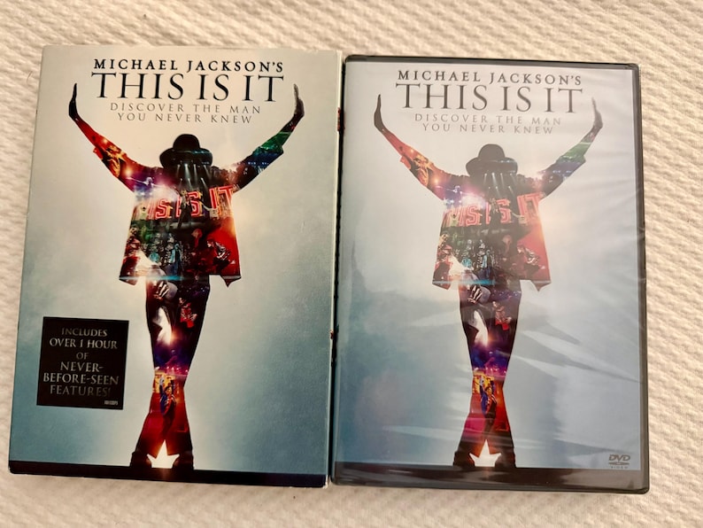 May include: Two DVD cases for Michael Jackson's This Is It, featuring a silhouette of a performer with arms raised against a light blue background. The cover text reads Michael Jackson's This Is It, Discover The Man You Never Knew.