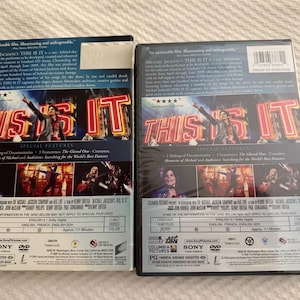 May include: Two identical DVD cases for Michael Jackson's This Is It. The back covers feature the film title in large red neon-style letters, images of the performer, and text detailing special features, technical specifications, and production credits.
