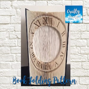 May include: A book with pages folded to create a clock face design. The Roman numerals are visible, and the text "Book Folding Pattern" is at the bottom. The upper right corner has the text "Crafty Hana".