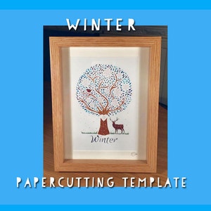 以下が含まれることがあります： 冬をテーマにした、額装された切り絵アート作品。 青と白の葉を持つ木、赤い鳥、鹿が描かれています。 フレームは明るい茶色の木製で、「WINTER」と「PAPERCUTTING TEMPLATE」の文字が表示されています。