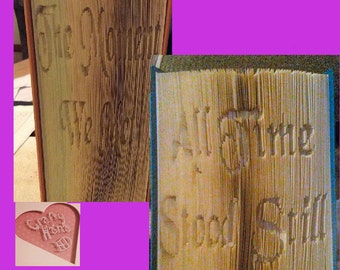 May include: Two open books with carved text. One book reads "The Moment We Met", the other reads "All Time Stood Still". A small heart-shaped cutout with the words "Crafty Home" is also visible.