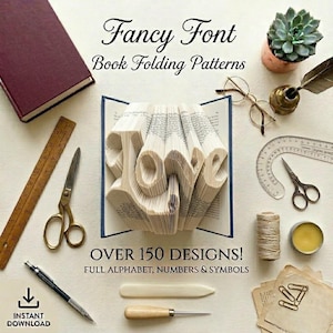 May include: An open book with the word "LOVE" folded into the pages, surrounded by craft supplies. The image includes a ruler, scissors, a pencil, and the text "Fancy Font Book Folding Patterns" and "Over 150 Designs!" with "Instant Download" text.