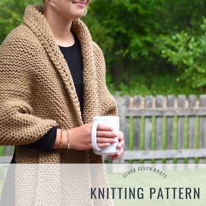 May include: A brown knitted shawl with a simple stitch pattern. The shawl is draped over a person's shoulders and they are holding a white mug. The text "Cluck Cluck Boots Knitting Pattern" is at the bottom of the image.