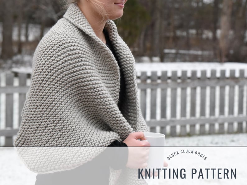 May include: A gray knitted shawl with a ribbed texture. The shawl is draped over a person's shoulders and they are holding a white mug. The text "Cluck Cluck Boots Knitting Pattern" is at the bottom of the image.