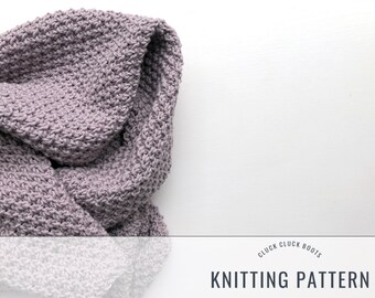 May include: A close-up of a knitted scarf in a muted purple hue. The scarf is folded, showcasing the textured stitch pattern. The words "KNITTING PATTERN" are displayed in a clean font at the bottom of the image.