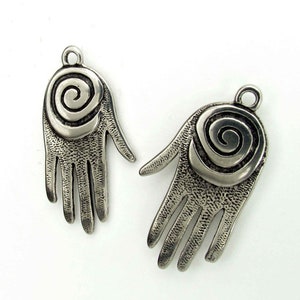 May include: Two silver hand-shaped charms with a spiral design in the center of each palm.