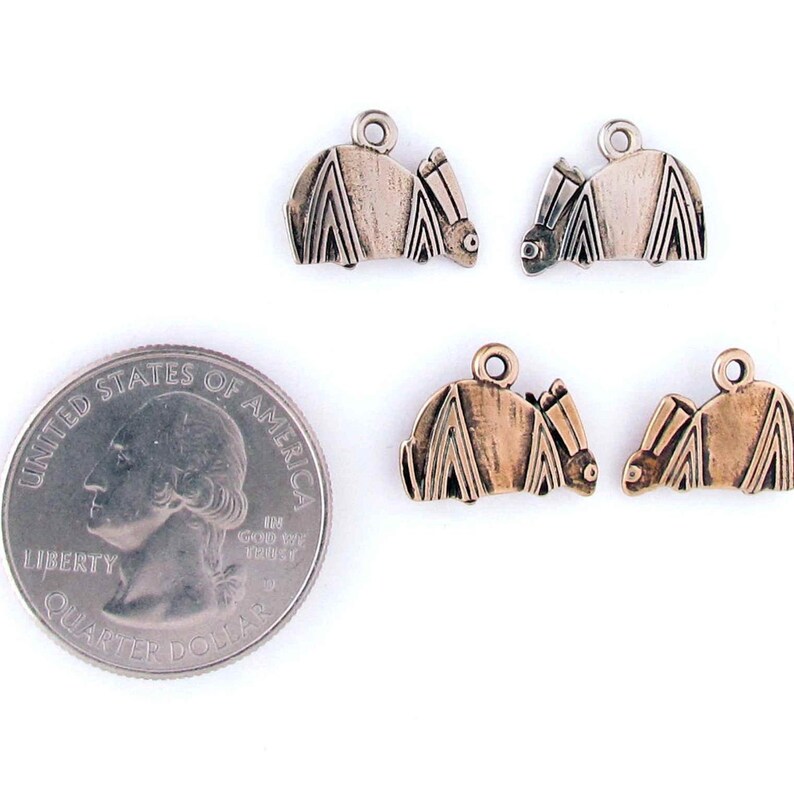 May include: Four silver and bronze bat charms with a loop for hanging. The charms are about the size of a US quarter.