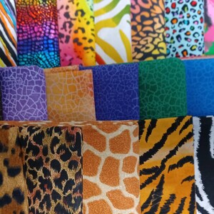May include: A collection of fabric swatches with various animal print patterns. The patterns include leopard spots, zebra stripes, giraffe spots, and other abstract designs in a variety of colors.