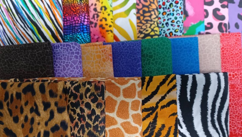 May include: A collection of fabric swatches with various animal print patterns. The patterns include leopard spots, zebra stripes, giraffe spots, and other abstract designs in a variety of colors.