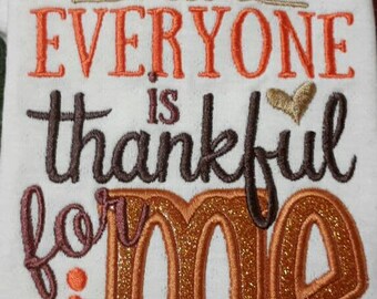 May include: White embroidered towel with the words "EVERYONE IS thankful for ME" in orange, brown, and gold glitter thread. A gold heart and decorative gold swirls are above the text. The towel is a Thanksgiving or fall-themed item.