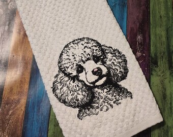 May include: White kitchen towel with a black and white embroidered image of a poodle.