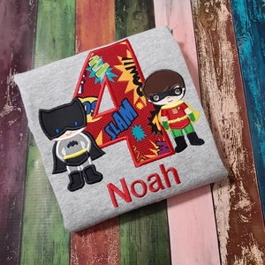 Super Hero Duo Birthday T-shirt.  Machine Embroidery and Applique with superhero and child's name and age in your choice of colors.