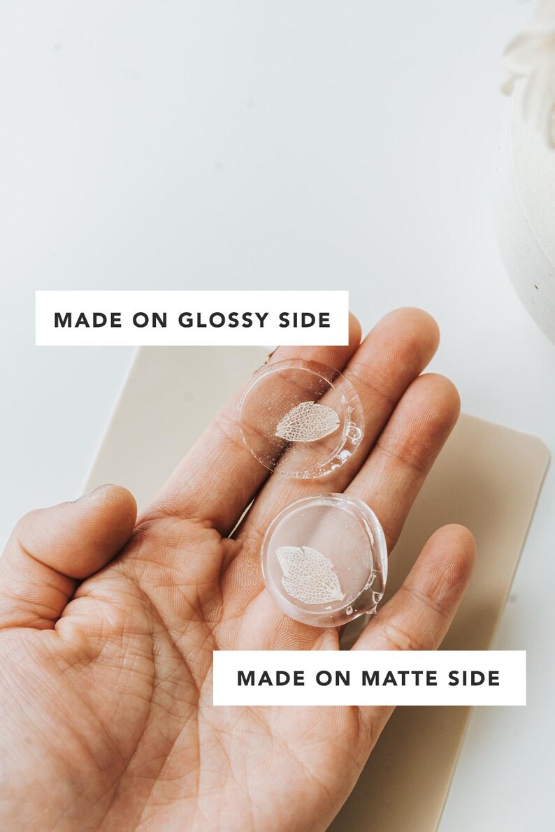 Two clear, wax seals with a leaf design are held in a hand. The text "MADE ON GLOSSY SIDE" and "MADE ON MATTE SIDE" are displayed on the image, indicating the different finishes.
