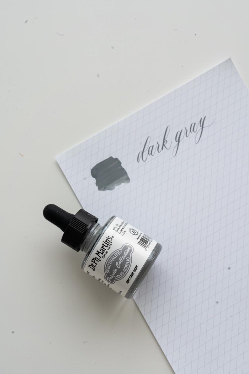 May include: A set of three ceramic mugs with a speckled, matte finish. The mugs are in shades of cream, light gray, and dark gray. Each mug has a simple, minimalist design and a rounded handle. Perfect for coffee or tea.