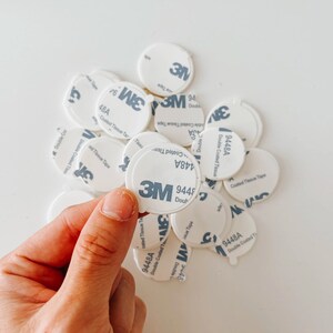 A pile of white, round, adhesive 3M double-sided adhesive