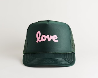 Love Valentine's Day Trucker Hat. Dark Green and Pink Hat For Valentine's Day. Puff Print Foam Trucker Hat. Love Script Font Trucker Hat.