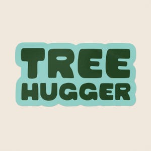 May include: A light blue sticker with the text "TREE HUGGER" in dark green letters.