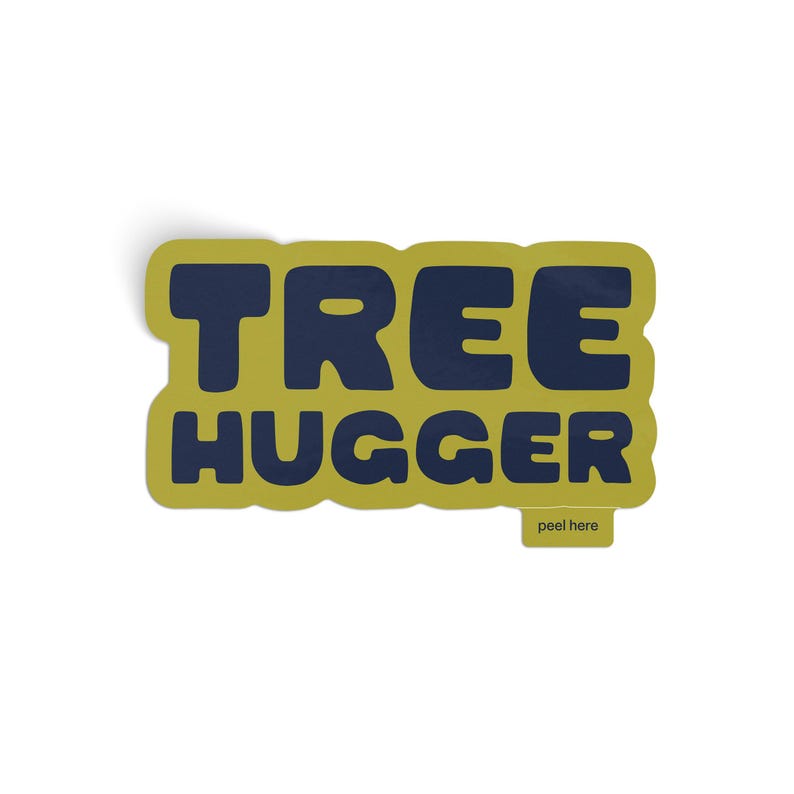Vinyl sticker that says 'tree hugger' in all caps chunky dark navy blue font with green background and a peel here tab on white background.