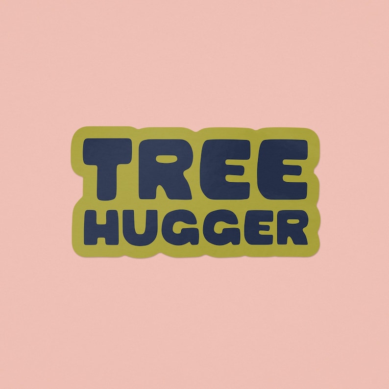 Vinyl sticker that says 'tree hugger' in all caps chunky dark navy blue font with green background and a peel here tab on pink background.