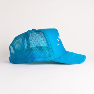 May include: A bright blue trucker hat with a white mesh back and a white logo that says "LIVE" on the front.