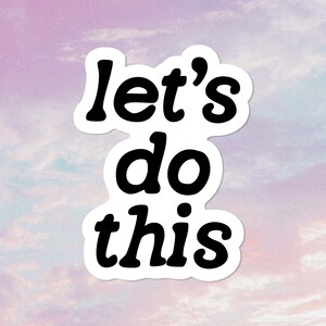 May include: A white sticker with black text that reads "let's do this" against a purple and blue background.