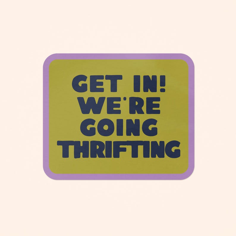 Bright green rectangular shaped sticker with rounded corners and purple border that says 'Get In! We're Going Thrifting!' and on a cream colored background