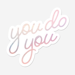 May include: A sticker with a pink and white iridescent finish featuring the text "you do you".