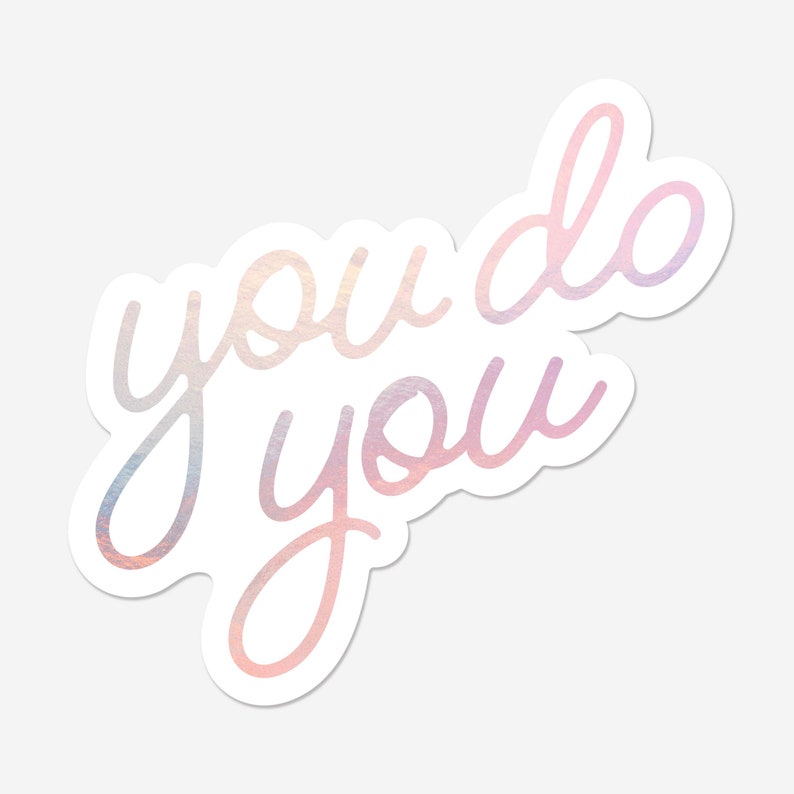 May include: A sticker with a pink and white iridescent finish featuring the text "you do you".