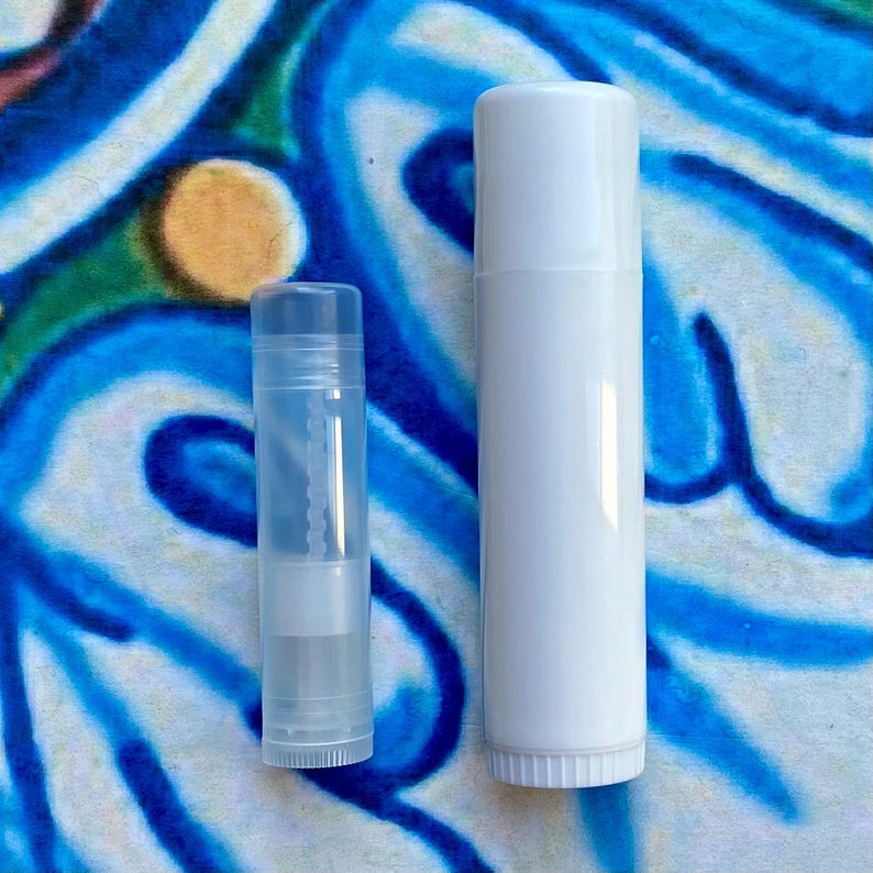 May include: Two clear lip balm tubes, one is larger than the other. The larger tube is white and the smaller tube is clear.
