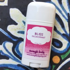 May include: White deodorant stick with a pink label that reads "BLISS DEODORANT" and "enough body" in a white cloud shape. The label also includes the ingredients and the text "HANDMADE IN RANCHO CORDOVA, CA www.enoughbody.etsy.com".