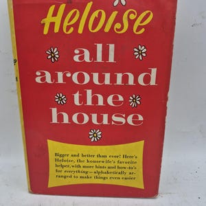 May include: A vintage book titled "Heloise all around the house." The cover is red with yellow and white text and daisy illustrations. The book promises hints and how-to's for everything, alphabetically arranged.