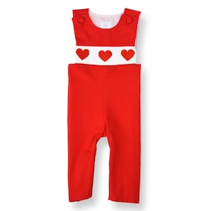 May include: Red overall romper with a white band and three red hearts on the front.