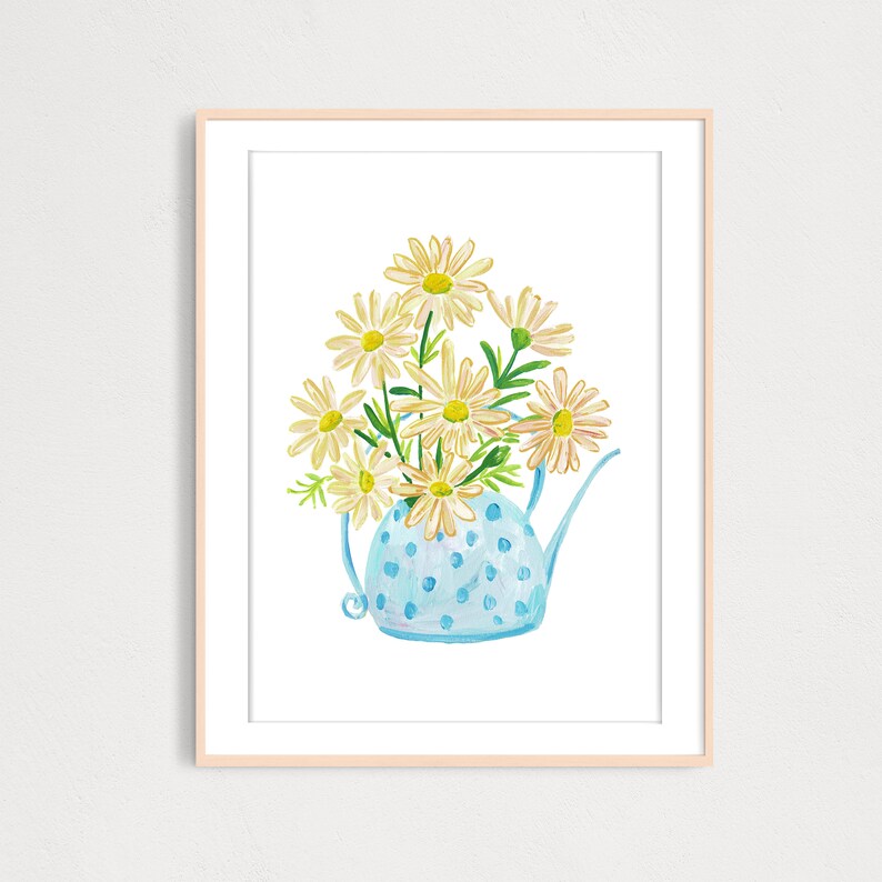 May include: A blue polka dot watering can with a white handle filled with a bouquet of white daisies.