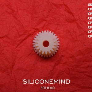 May include: A white plastic gear with a red center, on a red textured background. The text "SILICONEMIND STUDIO" and "ONKYO" with a list of model numbers is visible above the gear.