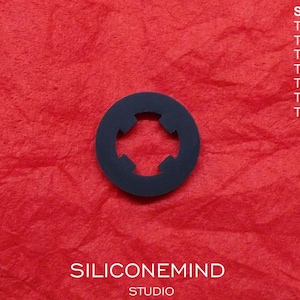 May include: A black plastic cassette tape adapter with five slots for different Sony cassette tape models. The adapter is on a red surface. The text "SILICONEMIND STUDIO" is printed below the adapter. The text "SONY" is printed above the adapter, followed by a list of Sony cassette tape models: TC-K5511, TC-K61, TC-K65, TC-U60, TC-K71, TC-K75, TC-K81.