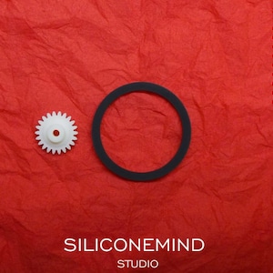 May include: A white plastic gear and a black rubber ring on a red textured surface. The text "SILICONEMIND STUDIO" is printed below the objects. The text "SHARP" is printed in the upper right corner of the image. The text "GF-500, GF-550, GF-700, GF-7500, GF-7500H, GX-250, GX-250ZR, QT-37H, QT-38Z" is printed below the text "SHARP".