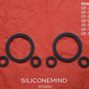 May include: Black rubber rings of various sizes on a red textured background. The text "SILICONEMIND STUDIO" is at the bottom of the image. The text "SHARP" is at the top of the image, followed by a list of model numbers: GF-767H/E, GF-777H, GF-999, GF-909, GF-919, GF-1000, GF-575Z/ZB.