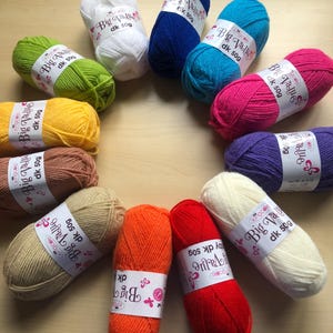 May include: A selection of colourful yarn skeins in shades like white, blue, pink, purple, green, yellow, brown, beige, orange, and red. Each skein is labelled with "Big Value dk 50g".