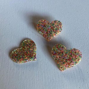 Multicolored sequined heart brooch.