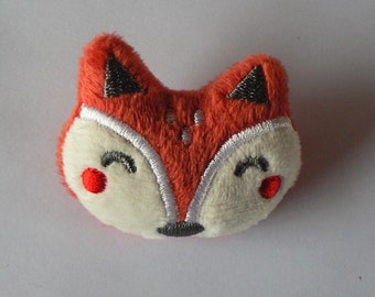 Fox fluff brooch.