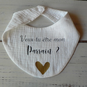 May include: White cotton baby bib with black text that reads "Veux-tu &ecirc;tre mon Parrain?" and a gold heart.