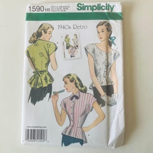 May include: Simplicity sewing pattern 1590 H5, featuring retro 1940s designs. The pattern includes illustrations of women's tops with various styles, including a peplum top and a striped shirt. The pattern size is US 6, 8, 10, 12, and 14.
