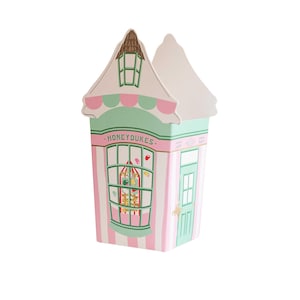 May include: A pink and green candy shop building with a white roof and a sign that says "Honeydukes". The shop window is filled with colorful candies.