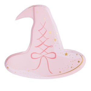 May include: A light pink witch hat-shaped paper plate with a pink ribbon design and gold star accents. The plate has a wide brim and a pointed top, perfect for a Halloween or themed party.