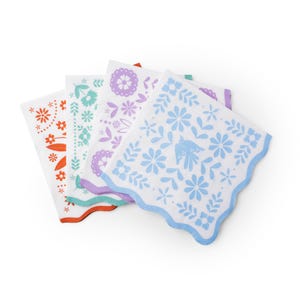 May include: Four white paper napkins with colorful floral designs. Each napkin features a different color scheme: orange, teal, purple, and blue. The napkins have scalloped edges and are arranged in a fan shape.